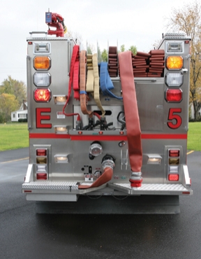 The compartment built into the driver’s side rear work platform contains a short five-inch curb jumper for making a big fire hookup. 