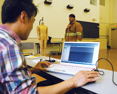 Huiju Park, Cornell University professor of fiber science and apparel design, records motion data of a firefighter wearing gear.