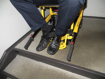 The patient foot rest has hook-and-loop straps to secure the patient's feet to the chair while descending the stairs