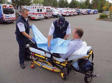 Once the crew members reach the ambulance, the patient can be transferred from the stair chair onto the gurney. 