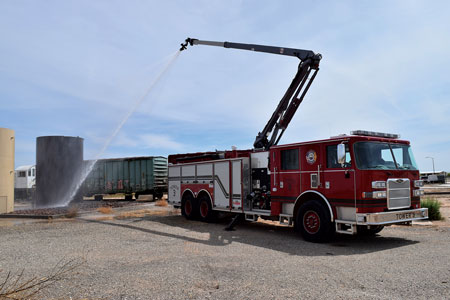 3 The Snozzle’s monitor and nozzle at the top of the waterway can rotate through 360 degrees and are controlled by a wireless remote control joystick. (Photo courtesy of Pierce Manufacturing.) 4 The Pierce Snozzle working a tank fire at a crude oil production facility. [Photo courtesy of the Malaga (NM) Volunteer Fire Department.]