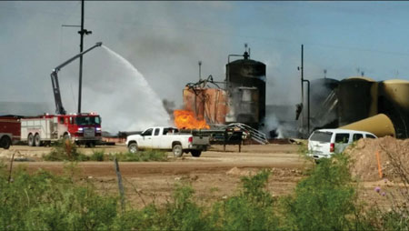 3 The Snozzle’s monitor and nozzle at the top of the waterway can rotate through 360 degrees and are controlled by a wireless remote control joystick. (Photo courtesy of Pierce Manufacturing.) 4 The Pierce Snozzle working a tank fire at a crude oil production facility. [Photo courtesy of the Malaga (NM) Volunteer Fire Department.]