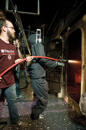 3 Virginia Tech engineering student Viktor Orekov backs up SAFFiR during its demonstration of its shipboard firefighting abilities aboard the USS Shadwell, a U.S. Navy experimental facility with a fire control laboratory.