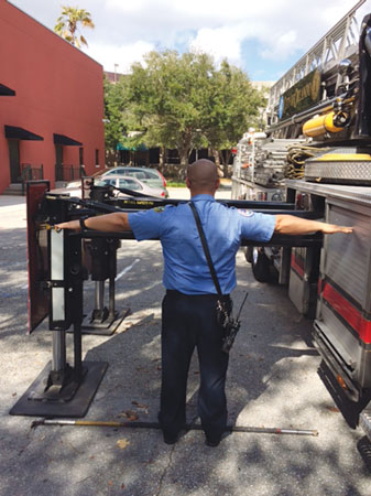 8 Each firefighter has different reach. This firefighter’s outstretched arms won’t work for estimating outrigger reach for this Stuphen 110-foot tower ladder. <em>(Photo by J.J. Cassetta.)</em> 