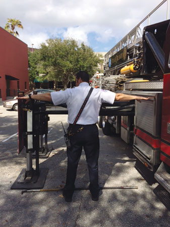 9 This firefighter’s reach is almost perfect for judging the outrigger’s maximum travel distance. <em>(Photo by J.J. Cassetta.)</em>