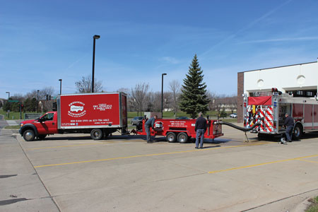 4 Emergency Apparatus Maintenance staff set up their equipment to pump test a Maple Grove (MN) Fire Department pumper. (Photo courtesy of Emergency Apparatus Maintenance