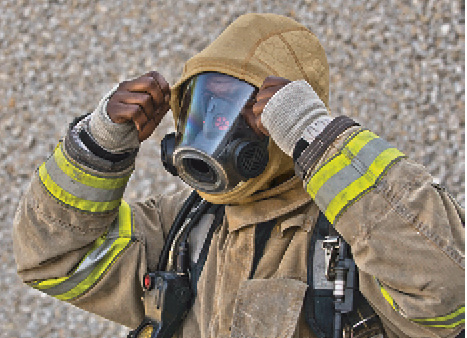 7 A firefighter dons a BarriAire Gold Hood made by PGI Inc. that gets its particulate blocking power from an inner layer of DuPont™ Nomex Nano Flex. (Photo courtesy of PGI Inc.)