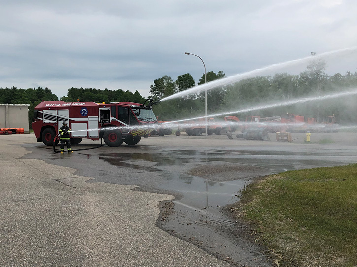 Sault Ste. Marie Airport firefighters operate all of the TITAN’s extinguishing systems at once during a training exercise. (Photo courtesy of the Sault Ste. Marie Airport.)