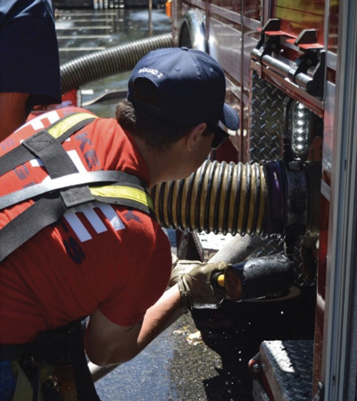 This intake valve was not equipped with a bleeder valve. The operator is tightening the connection after pressurize priming the intake and exhausting the air in the hard sleeve.