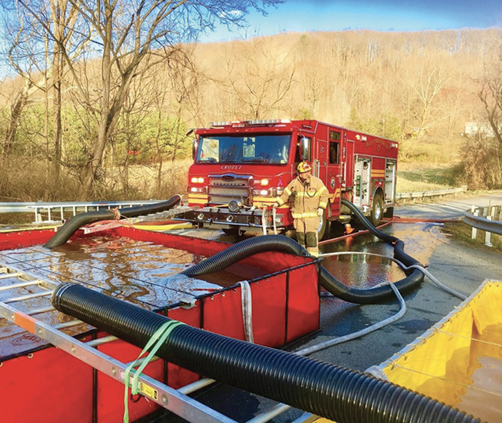 At this fire scene, the initial prime by the dump site engine was established through the front intake, and water was sent to the fire scene. As the flow demand at the scene increased, the operator expanded the system using a Twin Tube Setup to meet the demand.