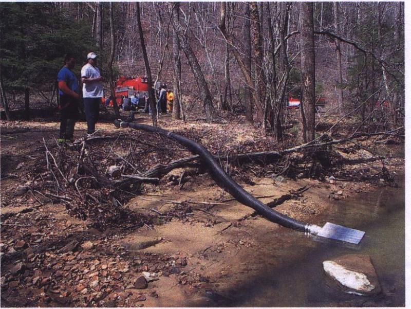 Vacuum tanker drafting 1000 GPM in shallow water from over 100 feet.