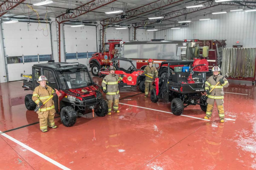 Firefighters with Polaris vehicles