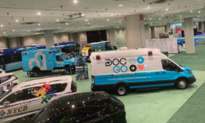 DocGo's electric ambulance parked on the show floor surrounded by other emergency vehicles.