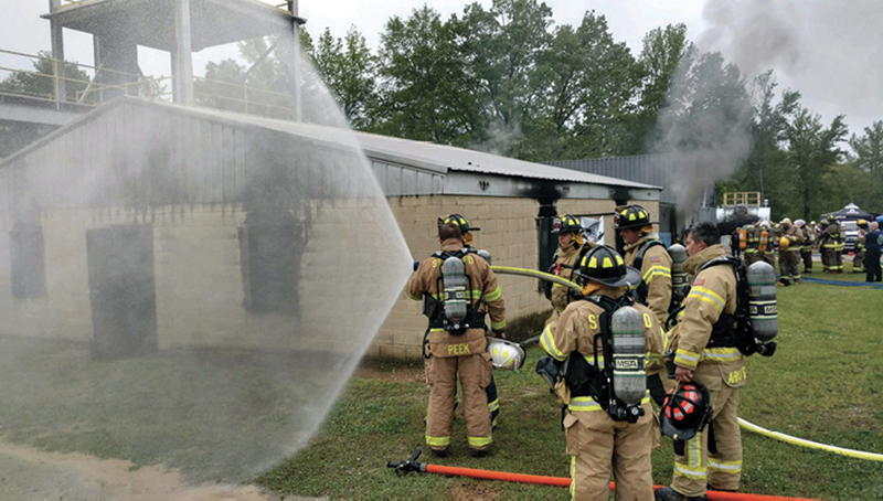 Firefighters test a Viper nozzle with the RYLSTATIC feature in a fog pattern.