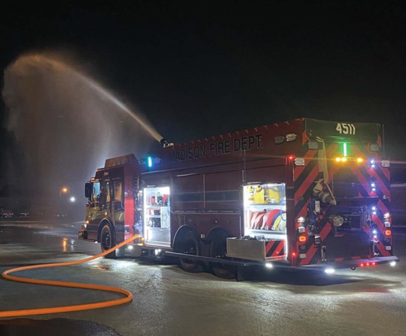 The pumper-tanker flowing water during a nighttime evolution.