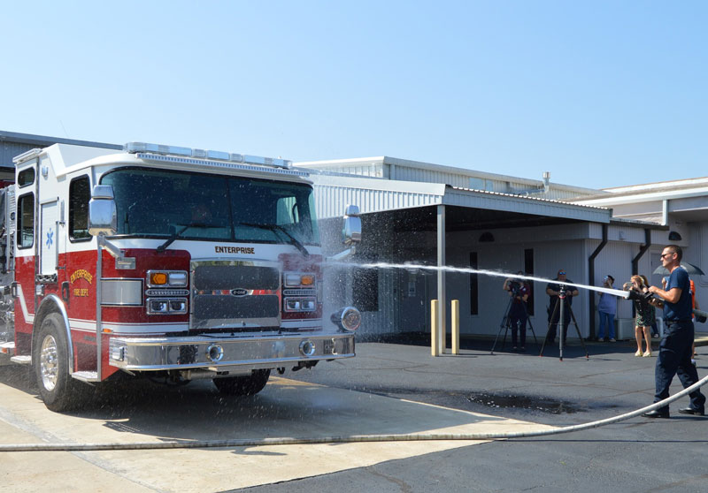 The 2023 E-One Typhoon fire engine was first sprayed by a 1997 E-One Cyclone II in a proverbial passing of the torch. (Source: Enterprise Fire Department Facebook page)