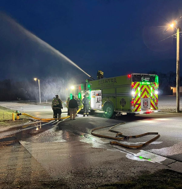 Palmyra firefighters flow water from the rescue-pumper's deck gun. (Courtesy of Palmyra Fire Department)