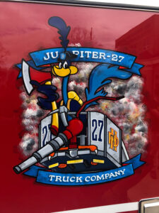 Holbrook NY, Jupiter Tower Ladder 27 has a unique roadrunner logo and the truck is dedicated to the memory of Firefighter Gerald Patrick Schrang who perished at the WTC on 9-11-01. (Photos by Mike Ciampo)