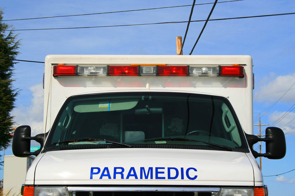 The front of a white ambulance with the word "paramedic" written on front.