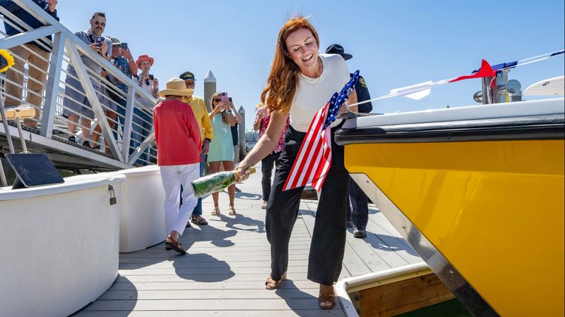 As Armando Quintero, left, Director, California Department of Parks and Recreation, and others look on, Elizabeth McGuirk, Chief Deputy Director at the California Department of Parks and Recreation, christens a new California State Park boat, Surf Watch 8, on the dock at the Orange County Sheriff s Department Harbor Patrol in Newport Beach on Friday, June 28, 2024. It is one of four new lifeguarding boats that will be coming to the State Parks in Orange County. (Photo by Mark Rightmire, Orange County Register/SCNG)