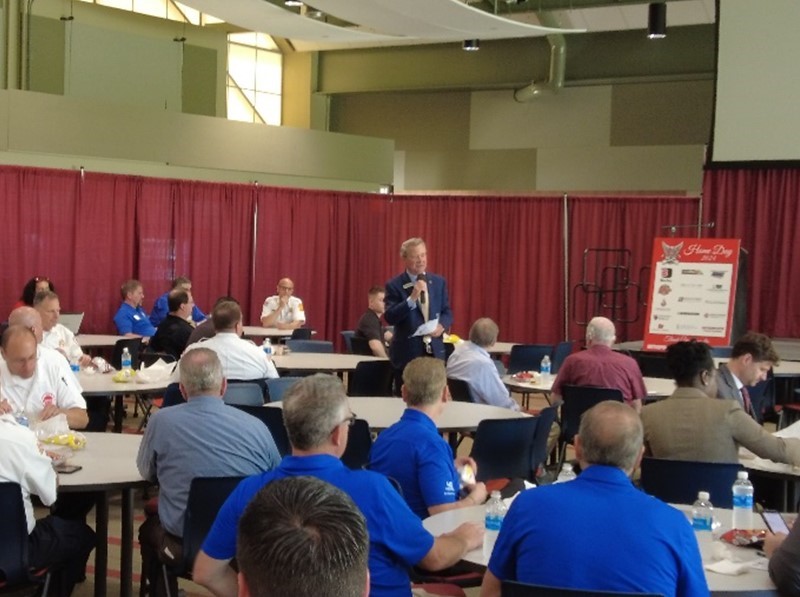 Paul Darley (standing), CEO of Darley, fire and defense equipment supplier, founded and co-chairs the annual Illinois Fire Service Home Day, held in Triton College’s EMT/Fire Science Program Building in River Grove, Illinois.