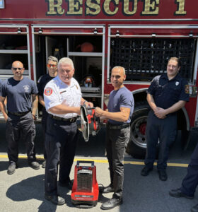 Here, Company President Phil Aberizk, Jr. (right) donates a high-end battery powered Milwaukee cutoff saw to Chief Robert O'Brien of the Haverhill Fire Department. These saws are used to cut cars away from people trapped by accidents, as well as cutting holes in metal roofs during structure fires. (Source: Merrimac Industrial Sales Facebook page)