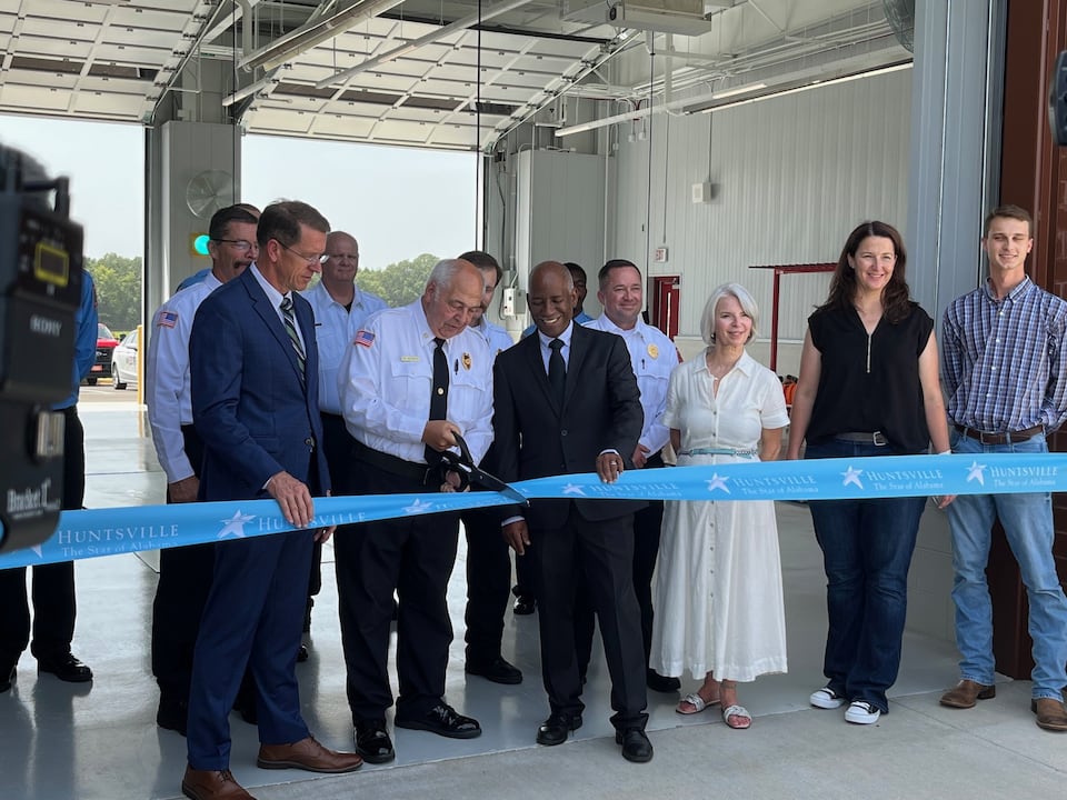 Huntsville Fire and Rescue Chief Howard McFarlen cuts the ribbon on Fire Station 20 while City Administrator John Hamilton, District 5 City Councilman John Meredith and station personnel look on Aug. 1, 2024. (Scott Turner)